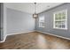 Charming dining area with hardwood floors, modern light fixture, and natural light from two large windows at 4115 Alvina Way, Myrtle Beach, SC 29579