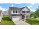 Charming two-story home with a white garage door, dark shutters, and a well-manicured lawn at 4115 Alvina Way, Myrtle Beach, SC 29579