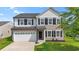 Charming two-story home with a white garage door, dark shutters, and a well-manicured lawn at 4115 Alvina Way, Myrtle Beach, SC 29579