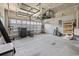 Spacious garage features overhead storage racks, shelving, and a windowed garage door for natural light at 4115 Alvina Way, Myrtle Beach, SC 29579