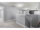 Upstairs hallway with neutral grey walls and carpet leading to multiple rooms at 4115 Alvina Way, Myrtle Beach, SC 29579