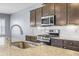 Close-up of a kitchen with stainless steel oven, granite countertops, and modern faucet at 4115 Alvina Way, Myrtle Beach, SC 29579