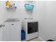 Functional laundry room featuring a modern washer and dryer, shelving, and ample space at 4115 Alvina Way, Myrtle Beach, SC 29579