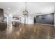 View of living room features hardwood floors leading to open kitchen and staircase at 4115 Alvina Way, Myrtle Beach, SC 29579