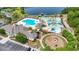 Aerial view of community pool with a slide, playground, and surrounding buildings at 4115 Alvina Way, Myrtle Beach, SC 29579