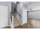 View of the carpeted staircase with wooden handrail leading to the upper level at 4115 Alvina Way, Myrtle Beach, SC 29579