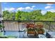 Cozy balcony overlooking lush greenery features comfortable seating and a beautiful view at 423 Parker Dr. # 334, Pawleys Island, SC 29585