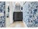 Powder room boasts a floral accent wall and pedestal sink at 423 Parker Dr. # 334, Pawleys Island, SC 29585