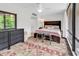 A bedroom featuring a large window, a bed, an oriental rug, and built-in storage at 423 Parker Dr. # 334, Pawleys Island, SC 29585
