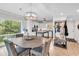 Bright dining space with a round table, tile floor, and a view of the kitchen with white cabinetry at 423 Parker Dr. # 334, Pawleys Island, SC 29585