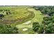 Overhead view of golf course surrounded by marsh and trees at 423 Parker Dr. # 334, Pawleys Island, SC 29585