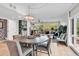 Open living room has a dining table, comfortable seating, and a large sliding glass door at 423 Parker Dr. # 334, Pawleys Island, SC 29585