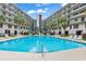Community pool surrounded by lounge chairs and lush landscaping at 423 Parker Dr. # 334, Pawleys Island, SC 29585
