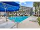 Inviting swimming pool surrounded by lounge chairs and palm trees at 423 Parker Dr. # 334, Pawleys Island, SC 29585