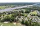 Aerial view of a house backing up to a golf course and waterway in a lush, green community at 4314 Turtle Ln., Little River, SC 29566