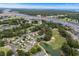 Aerial view of homes backing up to a waterway with a lush, green golf course and wooded areas at 4314 Turtle Ln., Little River, SC 29566