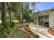 Backyard view of home with screened in porch and concrete patio with a landscaped walkway at 4314 Turtle Ln., Little River, SC 29566