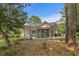Backyard view of home with wooden pergola, swing, patio and screened in back porch at 4314 Turtle Ln., Little River, SC 29566