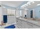 Elegant bathroom with dual sinks, granite countertops, bright lighting and a modern glass-enclosed shower at 4314 Turtle Ln., Little River, SC 29566