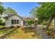 Backyard view of home with wooden pergola, swing, patio and screened in back porch at 4314 Turtle Ln., Little River, SC 29566