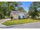 Charming single-story home with white siding, blue shutters, manicured lawn, mature trees, and a paved driveway at 4314 Turtle Ln., Little River, SC 29566
