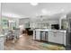 Bright kitchen with an island, stainless steel appliances, and hardwood floors, open to the living and dining areas at 4314 Turtle Ln., Little River, SC 29566