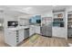 Bright kitchen showcasing stainless steel appliances, white cabinets, and an island with a sink at 4314 Turtle Ln., Little River, SC 29566