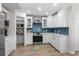Charming kitchen featuring white cabinets, a modern backsplash, and stainless steel appliances for a sleek, updated look at 4314 Turtle Ln., Little River, SC 29566