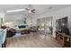 Comfortable living room with vaulted ceilings, a ceiling fan, and sliding doors that provide ample natural light at 4314 Turtle Ln., Little River, SC 29566