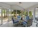 Relaxing sunroom featuring comfortable seating, a ceiling fan, and screened windows for outdoor views at 4314 Turtle Ln., Little River, SC 29566