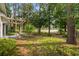 Landscaped backyard with a swing set under a wooden pergola and paver stone pathway at 4314 Turtle Ln., Little River, SC 29566