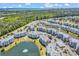 Expansive aerial view of the condo complex, showing pond, lush greenery, and cityscape in the distance at 4820 Magnolia Lake Dr. # 305, Myrtle Beach, SC 29577