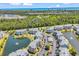 Scenic aerial view of the condo community with a pond, lush trees, and ample parking at 4820 Magnolia Lake Dr. # 305, Myrtle Beach, SC 29577