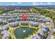Panoramic aerial view of condo community by pond, showcasing lush greenery and ample parking at 4820 Magnolia Lake Dr. # 305, Myrtle Beach, SC 29577