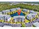 Aerial view of condo complex with a central pond, manicured grounds, and ample parking at 4820 Magnolia Lake Dr. # 305, Myrtle Beach, SC 29577