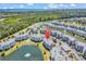 Stunning aerial view of condo complex with a pond, pool, and well-maintained grounds at 4820 Magnolia Lake Dr. # 305, Myrtle Beach, SC 29577