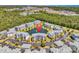 Aerial view shows a condo complex surrounded by lush greenery, a large pond, and parking areas at 4820 Magnolia Lake Dr. # 305, Myrtle Beach, SC 29577
