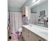 Bright bathroom featuring a double sink vanity, tiled flooring, and a shower with a curtain at 4820 Magnolia Lake Dr. # 305, Myrtle Beach, SC 29577