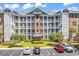Multi-level condominium building with parking, landscaping, and a well-maintained facade at 4820 Magnolia Lake Dr. # 305, Myrtle Beach, SC 29577