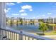 Picturesque pond view featuring manicured landscaping and residential buildings at 4820 Magnolia Lake Dr. # 305, Myrtle Beach, SC 29577