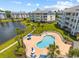 Attractive condo community pool surrounded by palm trees and well-manicured landscaping at 4820 Magnolia Lake Dr. # 305, Myrtle Beach, SC 29577