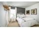 This bedroom features a large window for ample light and a decorative shelf with hooks on the wall at 5034 Selene Ct., Myrtle Beach, SC 29588
