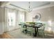 Elegant dining room with a stylish chandelier, wainscoting, and ample natural light at 5034 Selene Ct., Myrtle Beach, SC 29588