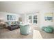 Bright living room with shiplap walls, coastal decor, and large windows offering ample natural light at 5034 Selene Ct., Myrtle Beach, SC 29588