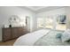 Serene bedroom featuring a large dresser, comfortable bed, and bright windows with scenic views at 5034 Selene Ct., Myrtle Beach, SC 29588