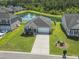 Aerial view of home with pond, fountain, lush green lawn, and manicured landscaping at 519 Royal Jay Ln., Longs, SC 29568