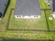 Aerial view of the fenced backyard, showing the covered patio, and the extensive grass area at 519 Royal Jay Ln., Longs, SC 29568