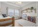 Bright bedroom featuring a ceiling fan and a place for children to play at 519 Royal Jay Ln., Longs, SC 29568