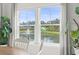 Bright dining area with plants and a view of the lake and fountain through large windows at 519 Royal Jay Ln., Longs, SC 29568
