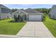 Charming single-story home featuring a well-manicured lawn and a two-car garage at 519 Royal Jay Ln., Longs, SC 29568